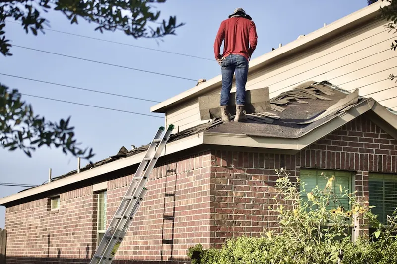 Professional roofer working on a residential roof in Greenfield Village